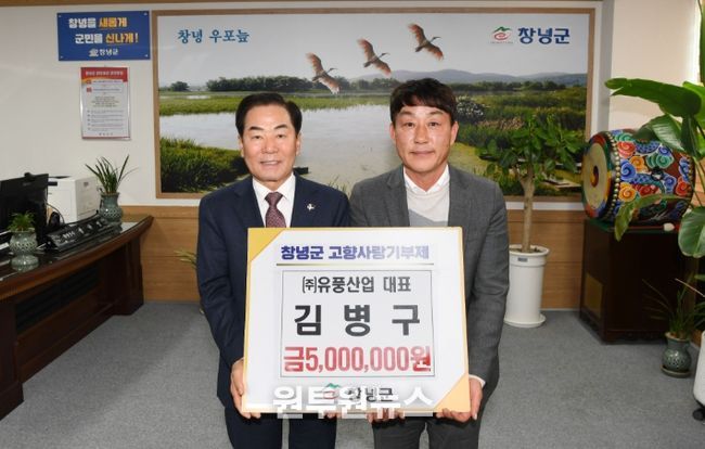 성낙인 창녕군수와 김병구 ㈜유풍산업 대표가 기탁식을 진행하며 기념촬영을 하고 있다.